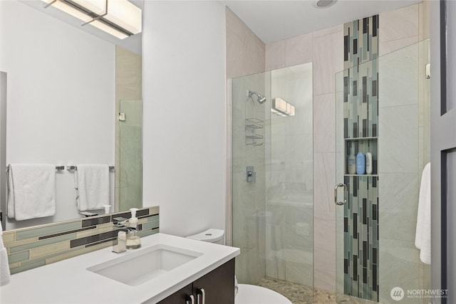 501 Maple Leaf Loop, Cle Elum, WA 98922 - full bathroom featuring toilet, vanity, a shower stall, and decorative backsplash