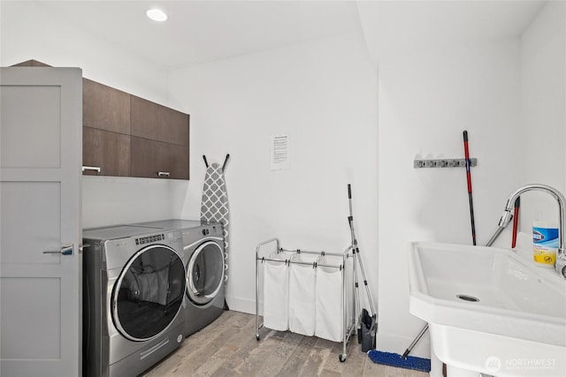 501 Maple Leaf Loop, Cle Elum, WA 98922 - laundry room featuring independent washer and dryer, cabinet space, light wood-style floors, and recessed lighting