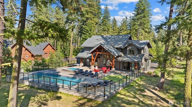 501 Maple Leaf Loop, Cle Elum, WA 98922 - rear view of property with an in-ground hot tub, a patio, and a shingled roof