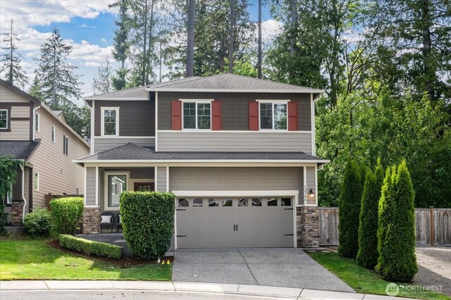 12304 55th Dr SE, Snohomish, WA 98296 - view of front of property with concrete driveway, stone siding, a garage, and roof with shingles