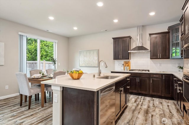 12304 55th Dr SE, Snohomish, WA 98296 - kitchen with a sink, stainless steel appliances, light wood-type flooring, light countertops, and wall chimney range hood