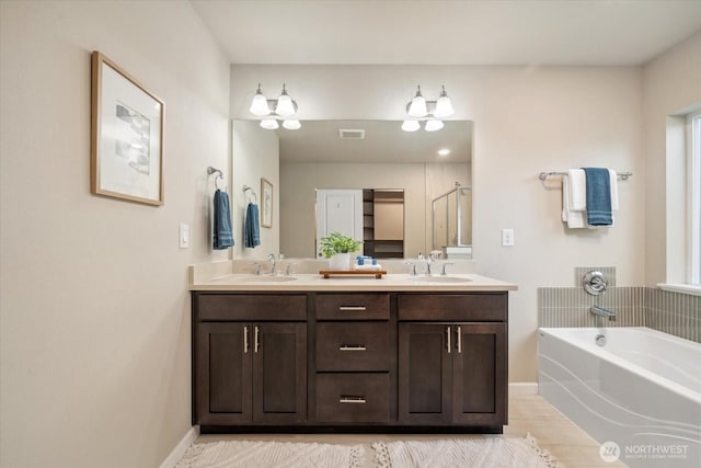 12304 55th Dr SE, Snohomish, WA 98296 - full bathroom with double vanity, a bath, a stall shower, and baseboards