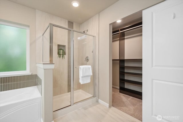12304 55th Dr SE, Snohomish, WA 98296 - bathroom with a shower stall, a walk in closet, a bath, and recessed lighting