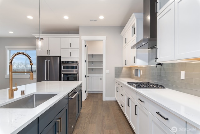 13045 75th Pl S, Seattle, WA 98178 - kitchen with wall chimney exhaust hood, a sink, stainless steel appliances, white cabinets, and dark wood-style flooring