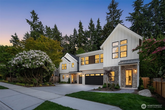 12833 NE 91st St, Kirkland, WA 98033 - view of front of house featuring board and batten siding, an attached garage, driveway, stone siding, and a standing seam roof