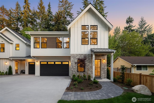 12833 NE 91st St, Kirkland, WA 98033 - view of front of house with an attached garage, board and batten siding, driveway, stone siding, and a standing seam roof