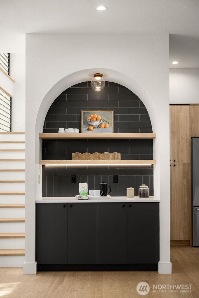 12833 NE 91st St, Kirkland, WA 98033 - bar area with freestanding refrigerator, light wood finished floors, decorative backsplash, recessed lighting, and stairway