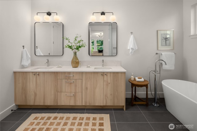12833 NE 91st St, Kirkland, WA 98033 - bathroom featuring tile patterned flooring, double vanity, a freestanding bath, and baseboards