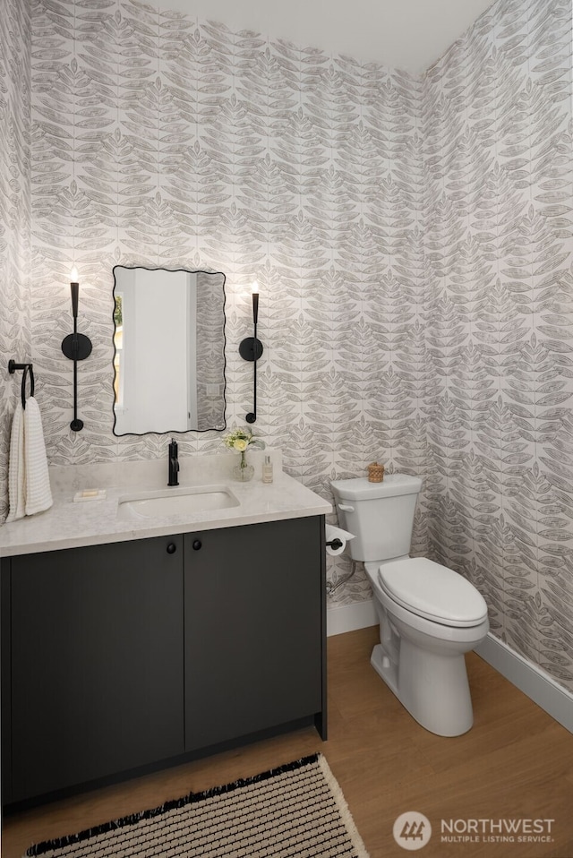 12833 NE 91st St, Kirkland, WA 98033 - bathroom featuring vanity, toilet, wallpapered walls, wood finished floors, and baseboards