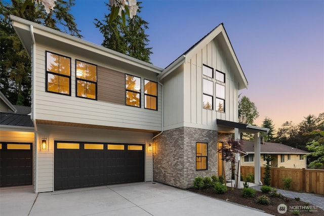 12833 NE 91st St, Kirkland, WA 98033 - view of front of house featuring board and batten siding, concrete driveway, and an attached garage