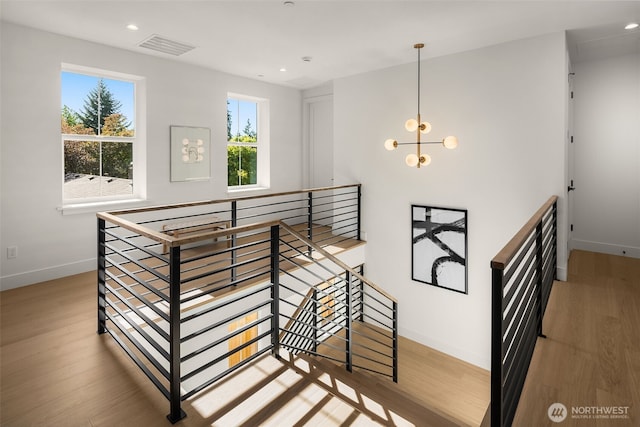 12833 NE 91st St, Kirkland, WA 98033 - stairway with baseboards, wood finished floors, recessed lighting, and a chandelier