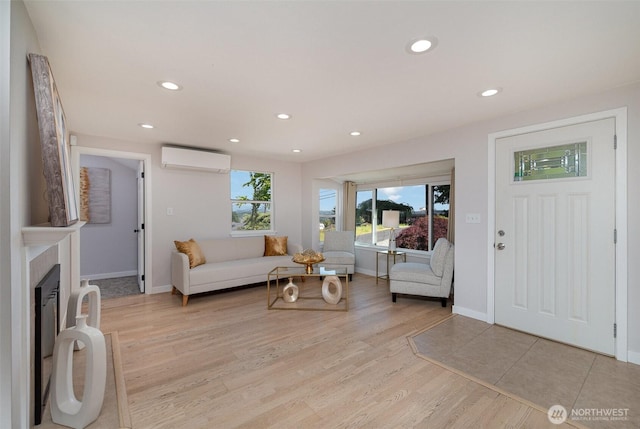 7408 S 128th St, Seattle, WA 98178 - living room featuring a wall mounted air conditioner, light wood finished floors, recessed lighting, baseboards, and a fireplace with raised hearth