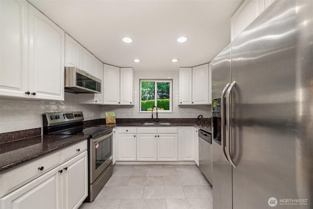 7408 S 128th St, Seattle, WA 98178 - kitchen with appliances with stainless steel finishes, a sink, white cabinetry, dark stone countertops, and recessed lighting