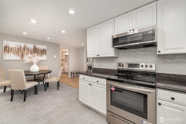 7408 S 128th St, Seattle, WA 98178 - kitchen with stainless steel appliances, recessed lighting, decorative backsplash, white cabinetry, and dark stone counters