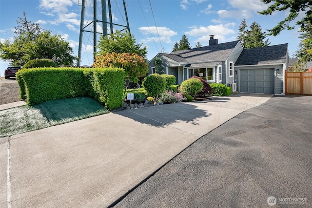 7408 S 128th St, Seattle, WA 98178 - view of front facade with a garage, asphalt driveway, and a chimney