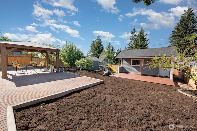 7408 S 128th St, Seattle, WA 98178 - fenced backyard with a gazebo, a wooden deck, a patio area, and an outbuilding