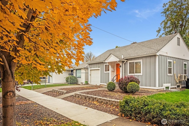 207 N Colville St, Walla Walla, WA 99362 - view of front of property with board and batten siding, an attached garage, a shingled roof, and driveway