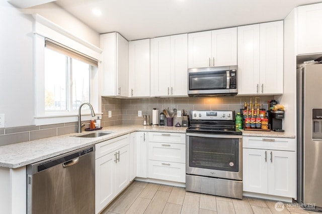 207 N Colville St, Walla Walla, WA 99362 - kitchen featuring appliances with stainless steel finishes, a sink, white cabinets, and backsplash