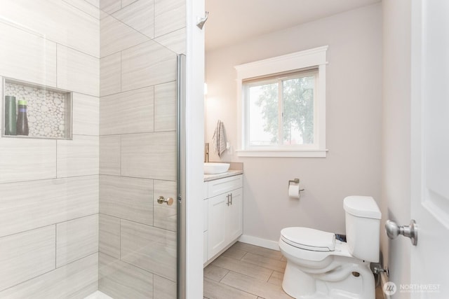 207 N Colville St, Walla Walla, WA 99362 - full bath featuring toilet, vanity, a stall shower, baseboards, and wood tiled floors