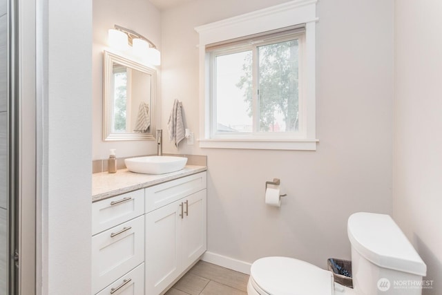 207 N Colville St, Walla Walla, WA 99362 - bathroom featuring toilet, vanity, and baseboards