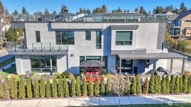 903 N 33rd Pl, Renton, WA 98056 - rear view of house featuring stucco siding and a pergola