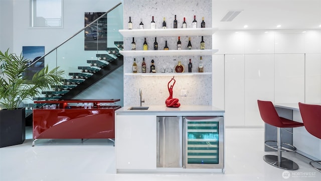 903 N 33rd Pl, Renton, WA 98056 - indoor wet bar featuring wine cooler, stairway, tasteful backsplash, and finished concrete flooring