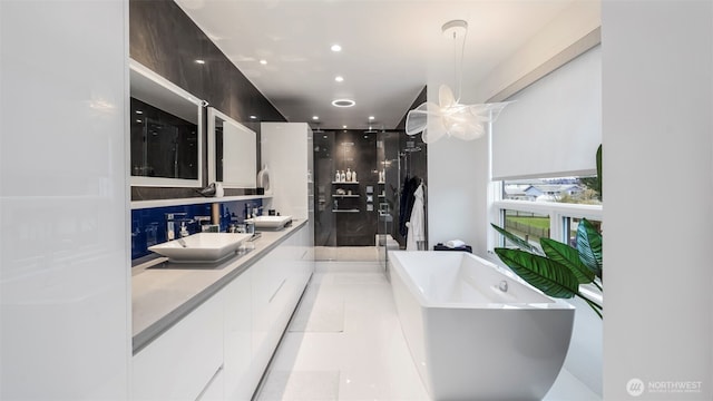 903 N 33rd Pl, Renton, WA 98056 - bathroom with a stall shower, double vanity, a soaking tub, and recessed lighting