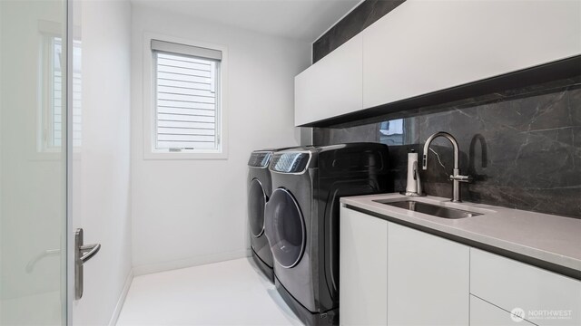 903 N 33rd Pl, Renton, WA 98056 - laundry room with cabinet space, washer and clothes dryer, healthy amount of natural light, and baseboards