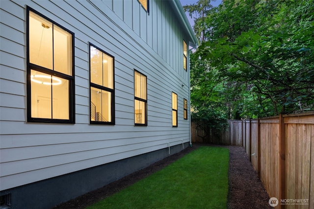 12837 NE 91st St, Kirkland, WA 98033 - view of side of home with board and batten siding and a fenced backyard