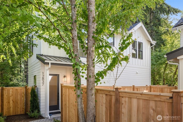 12837 NE 91st St, Kirkland, WA 98033 - view of property exterior featuring a standing seam roof, board and batten siding, and a metal roof