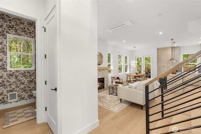 12837 NE 91st St, Kirkland, WA 98033 - living room featuring light wood-style floors, a fireplace, stairs, and recessed lighting