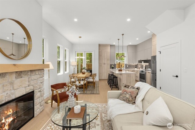 12837 NE 91st St, Kirkland, WA 98033 - living room featuring light wood-type flooring, recessed lighting, and a glass covered fireplace