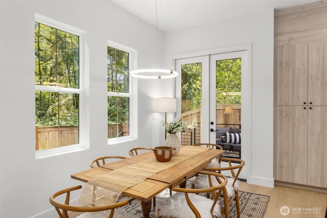 12837 NE 91st St, Kirkland, WA 98033 - dining area with healthy amount of natural light, french doors, and light wood finished floors