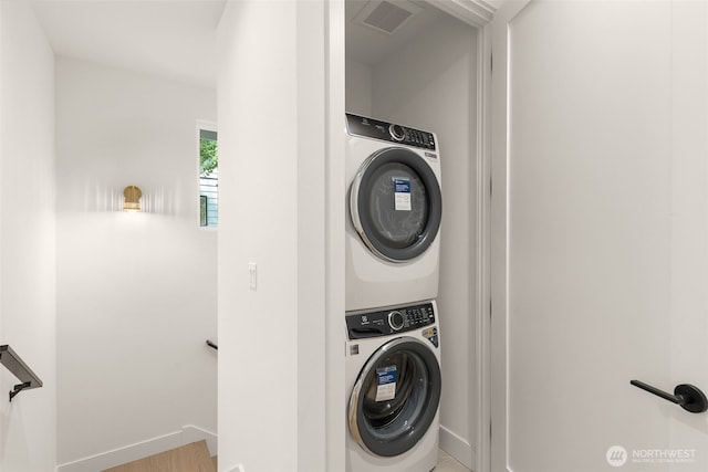 12837 NE 91st St, Kirkland, WA 98033 - laundry room featuring stacked washing machine and dryer and wood finished floors