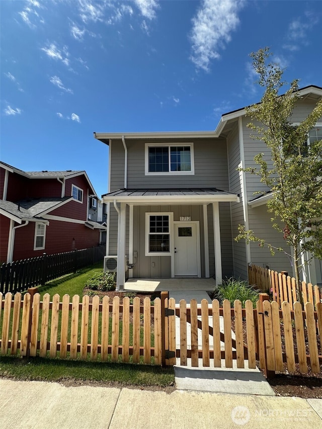 1712 Sunup Loop, Bellingham, WA 98226 - view of front of house with covered porch, a standing seam roof, a metal roof, a fenced front yard, and board and batten siding