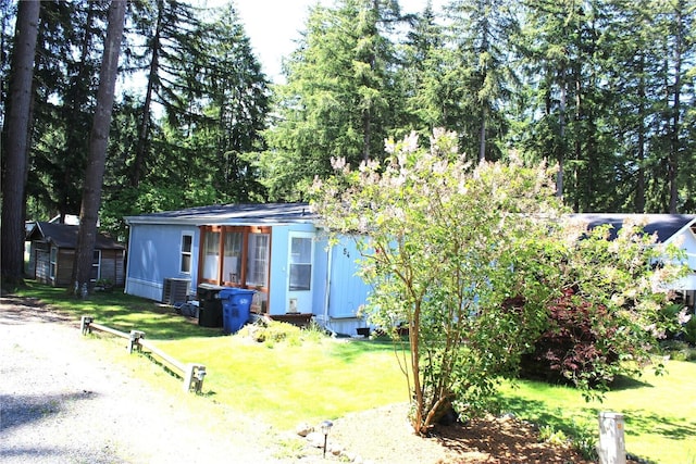 17340 Sargent Rd SW Unit 54, Rochester, WA 98579 - view of front of home featuring an outbuilding, a front lawn, and central AC