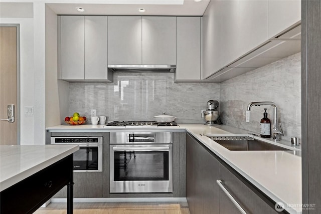 2510 6th Ave Unit 2003, Seattle, WA 98121 - kitchen featuring stainless steel oven, a sink, gas cooktop, and backsplash