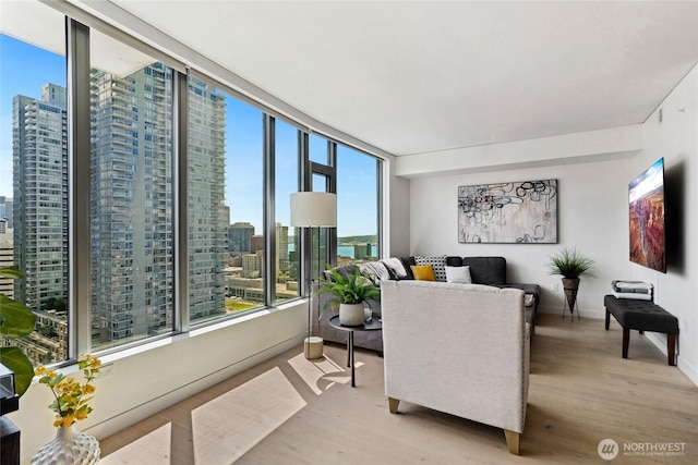 2510 6th Ave Unit 2003, Seattle, WA 98121 - living area featuring light wood-style floors, a view of skyline, and baseboards