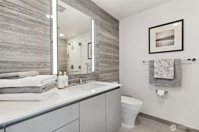 2510 6th Ave Unit 2003, Seattle, WA 98121 - full bath with toilet, vanity, a shower stall, tile patterned flooring, and baseboards