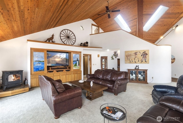 280 Surf St, Westport, WA 98595 - living room featuring carpet floors, a skylight, wooden ceiling, high vaulted ceiling, and a wood stove