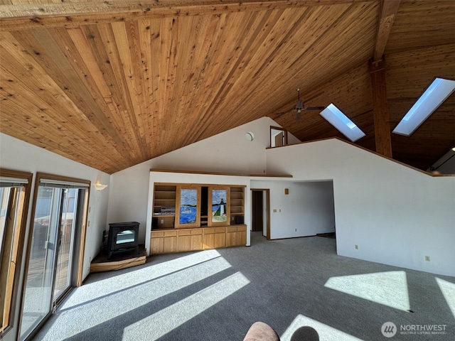 280 Surf St, Westport, WA 98595 - unfurnished living room with a wood stove, wooden ceiling, carpet flooring, a skylight, and high vaulted ceiling