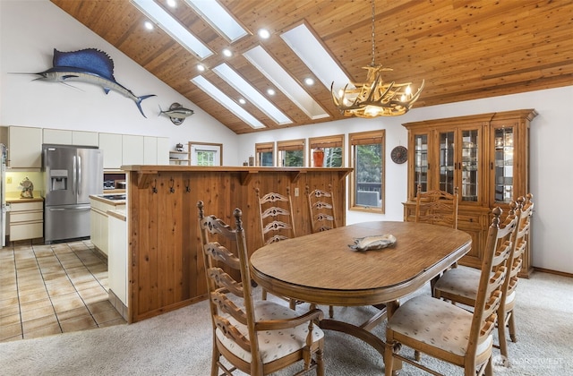 280 Surf St, Westport, WA 98595 - dining space featuring a skylight, a chandelier, wood ceiling, light colored carpet, and recessed lighting