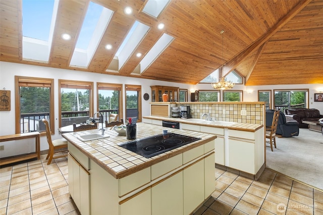 280 Surf St, Westport, WA 98595 - kitchen featuring tile counters, black electric stovetop, a sink, light tile patterned floors, and recessed lighting
