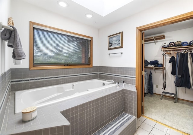 280 Surf St, Westport, WA 98595 - full bathroom with a bath, tile patterned floors, a spacious closet, a skylight, and recessed lighting