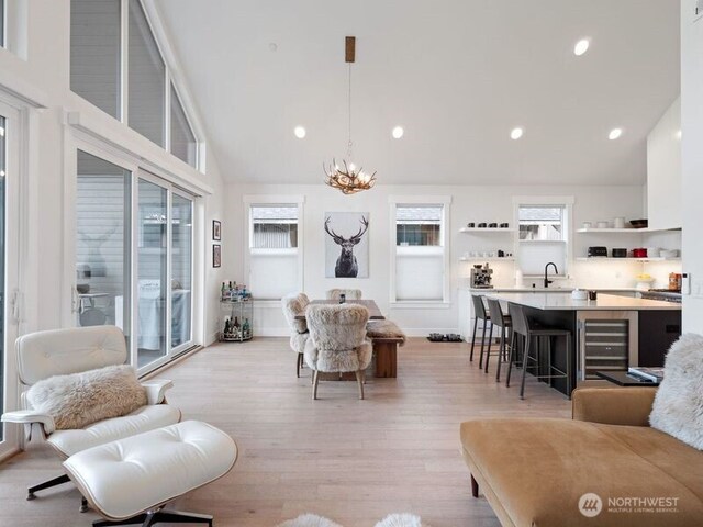 30 Symphony Ct, Cle Elum, WA 98922 - living area featuring beverage cooler, light wood-style floors, a chandelier, recessed lighting, and high vaulted ceiling