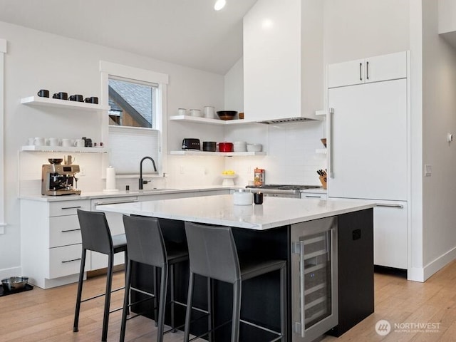 30 Symphony Ct, Cle Elum, WA 98922 - kitchen featuring beverage cooler, open shelves, high end fridge, light wood-style floors, and a kitchen bar