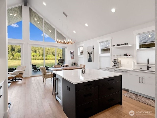 30 Symphony Ct, Cle Elum, WA 98922 - kitchen with dark cabinetry, a center island, white cabinetry, decorative light fixtures, and light wood finished floors