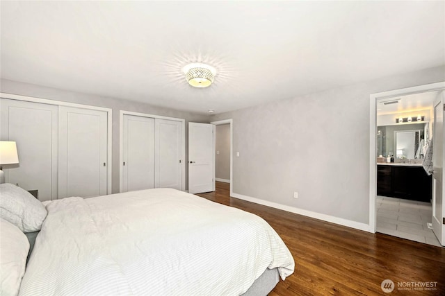 3908 NE 103rd St, Seattle, WA 98125 - bedroom with two closets, dark wood finished floors, and connected bathroom
