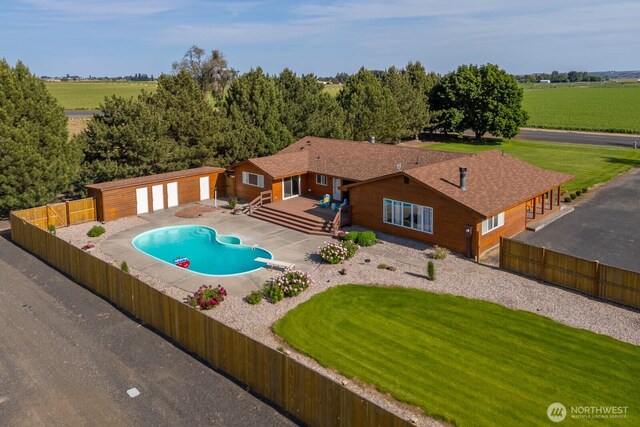 710 S Mckinney Rd, Othello, WA 99344 - view of swimming pool with a wooden deck, an outbuilding, a diving board, and a patio