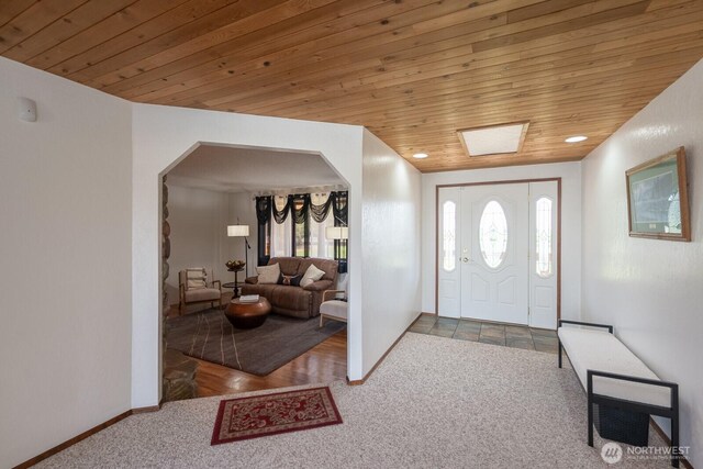 710 S Mckinney Rd, Othello, WA 99344 - carpeted foyer featuring wood ceiling, arched walkways, healthy amount of natural light, and baseboards